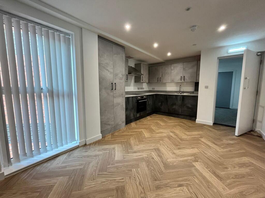 A modern kitchenette with ample space and brigh...