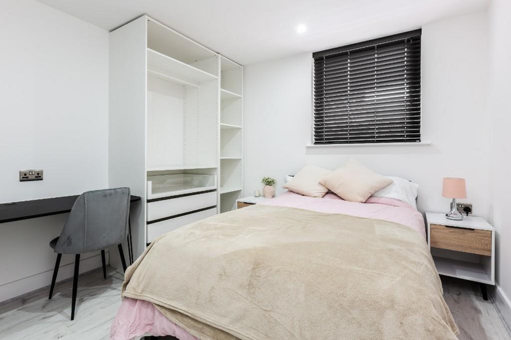 A bright and inviting double bedroom with moder...