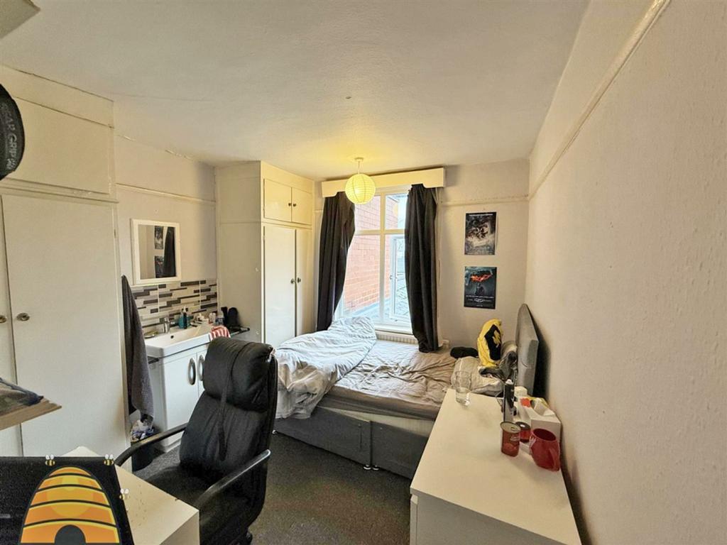 A cozy and well-lit double bedroom with ample s...