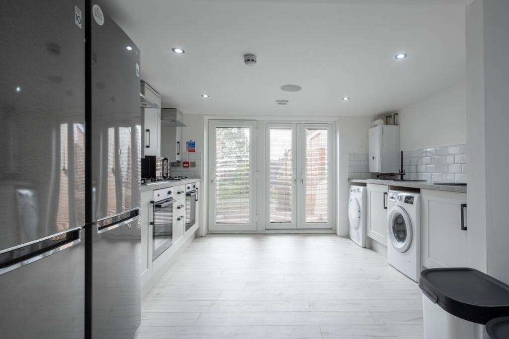 Bright and modern kitchen featuring sleek appli...