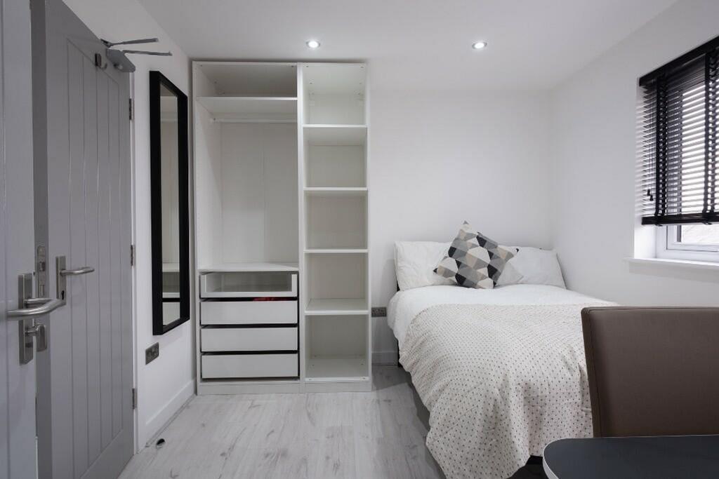 A bright and modern double bedroom featuring a ...