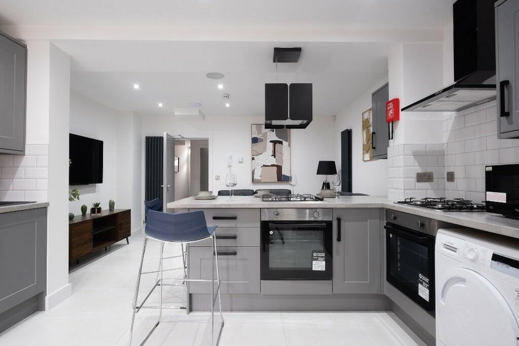 A modern kitchen featuring sleek cabinetry and ...