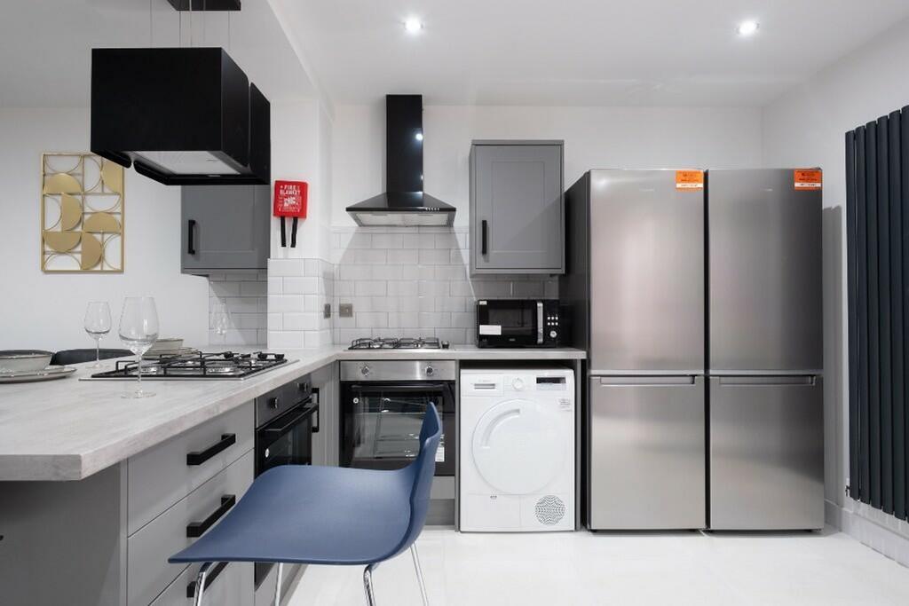 Modern kitchen featuring sleek cabinetry, high-...