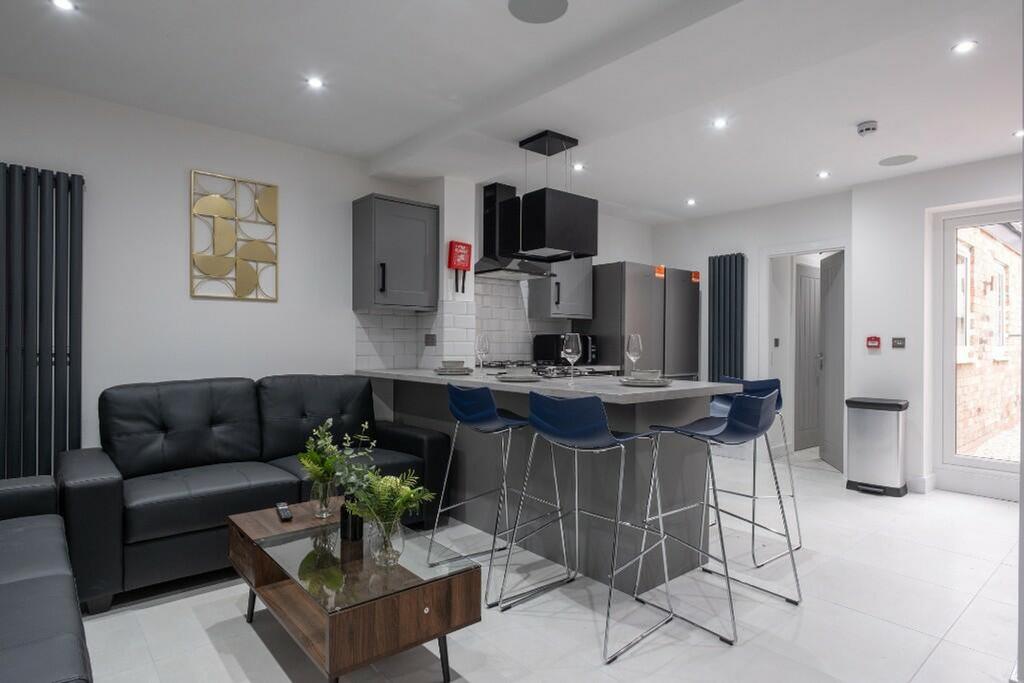 Modern kitchen featuring sleek cabinetry, ample...