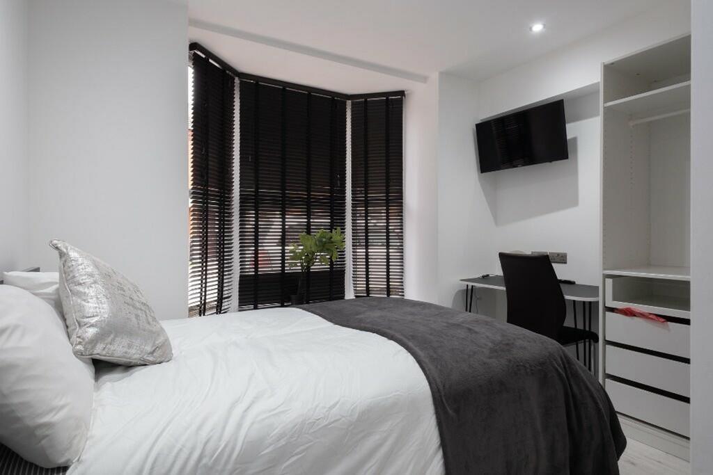 A stylish double bedroom featuring a comfortabl...