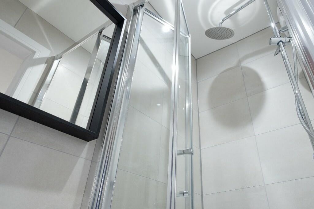 Modern bathroom featuring a sleek shower with c...