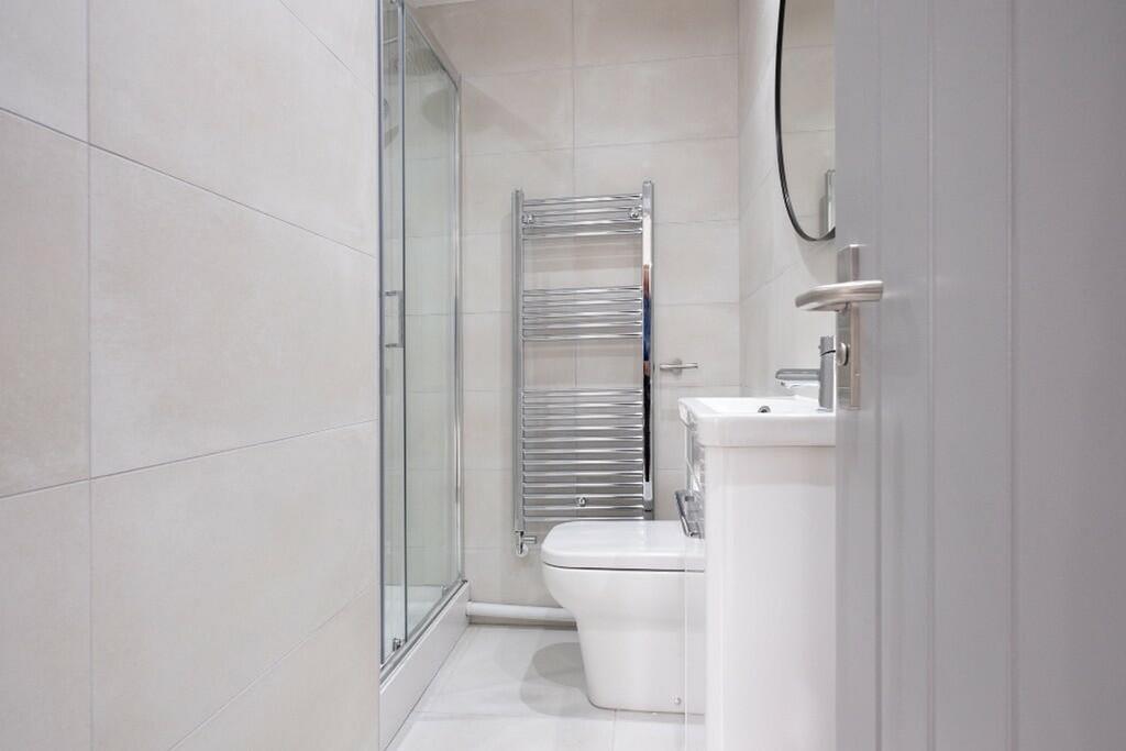 Modern bathroom suite featuring sleek tiles, a ...