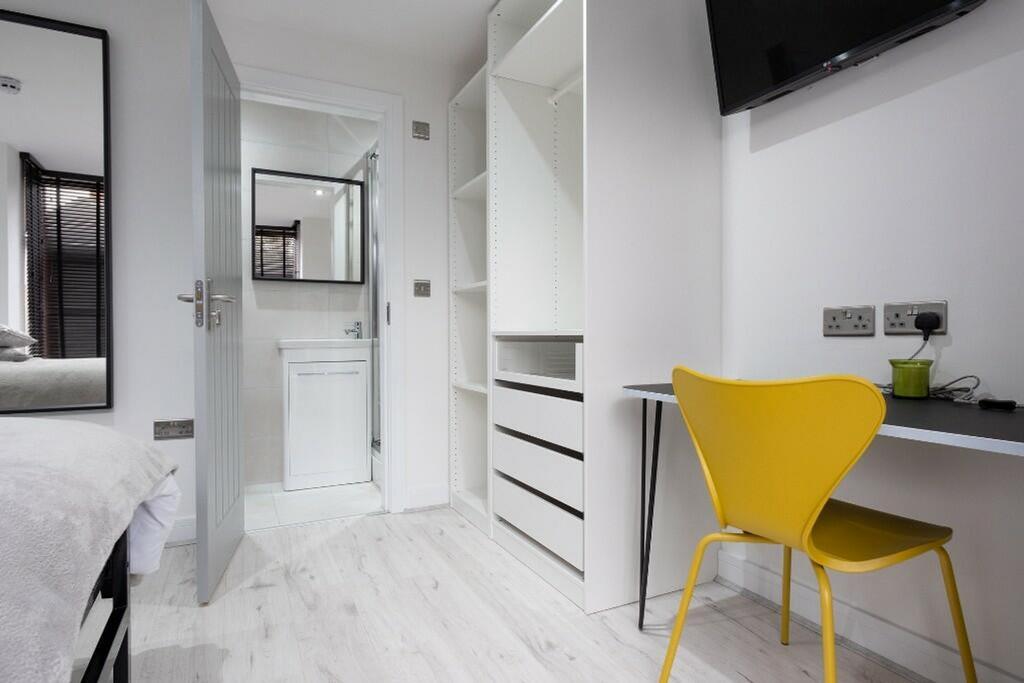 This stylish double bedroom features modern fur...