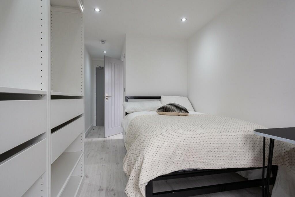 This inviting double bedroom features a cozy be...