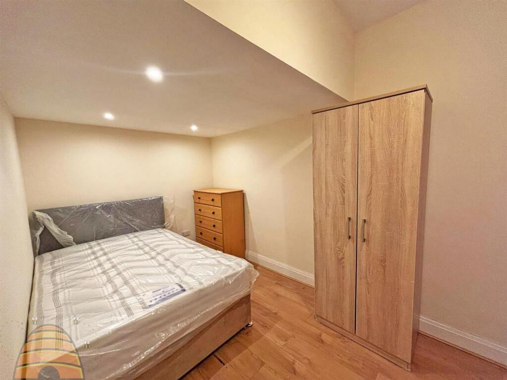 A bright and inviting double bedroom featuring ...
