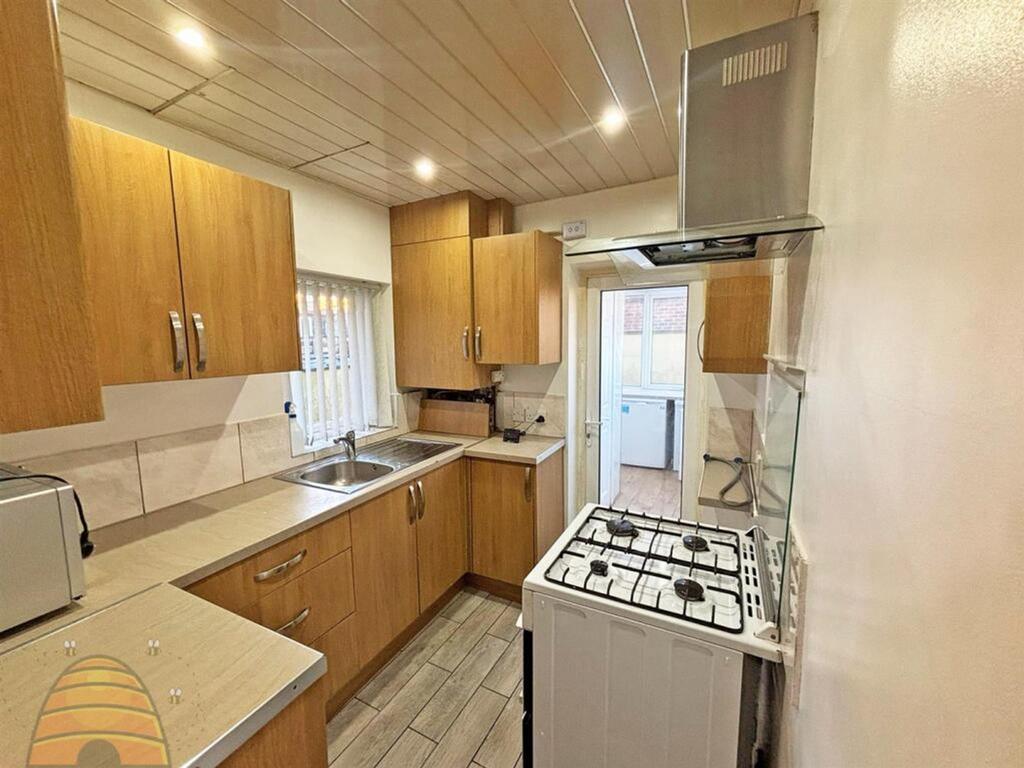 A bright and modern kitchen featuring ample sto...
