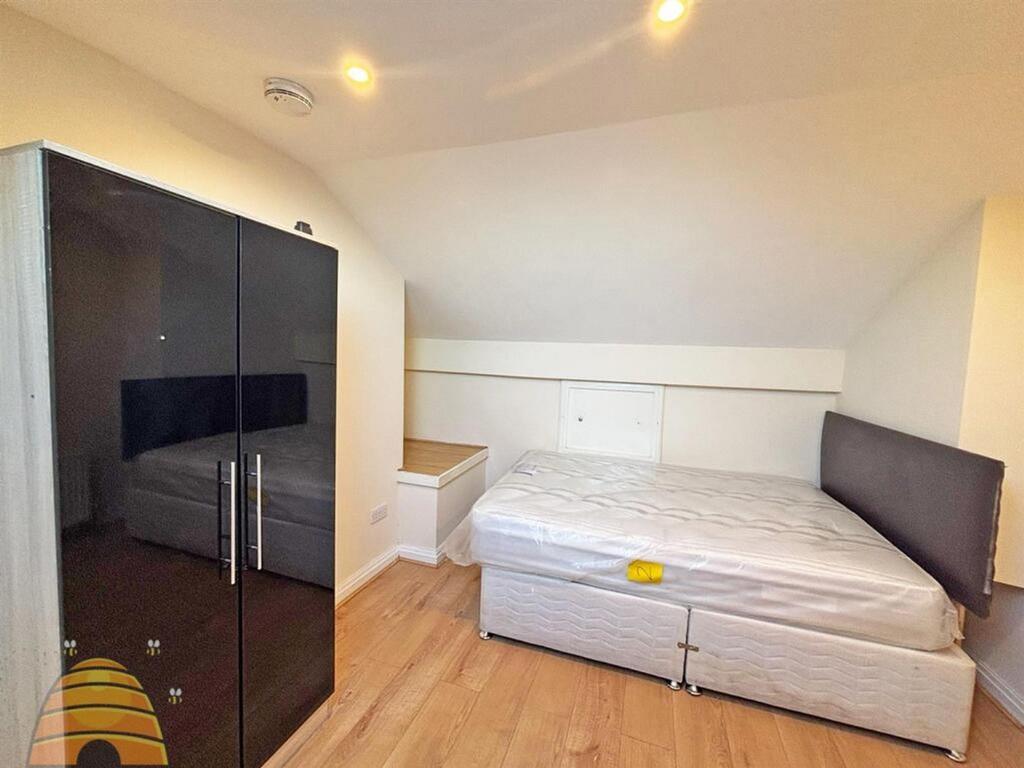 A spacious and tidy double bedroom with ample n...