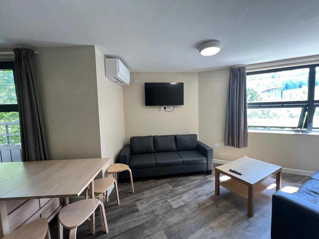 Bright, modern living room with large windows, ...