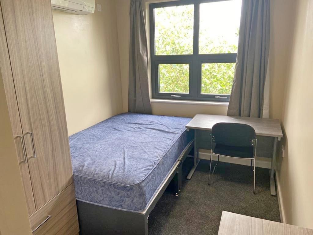 This cozy double bedroom features a comfortable...