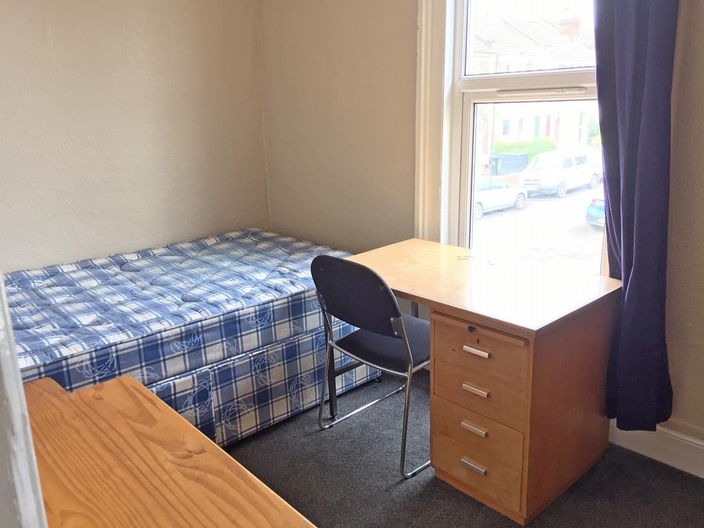 Bright and cozy double bedroom featuring a comf...