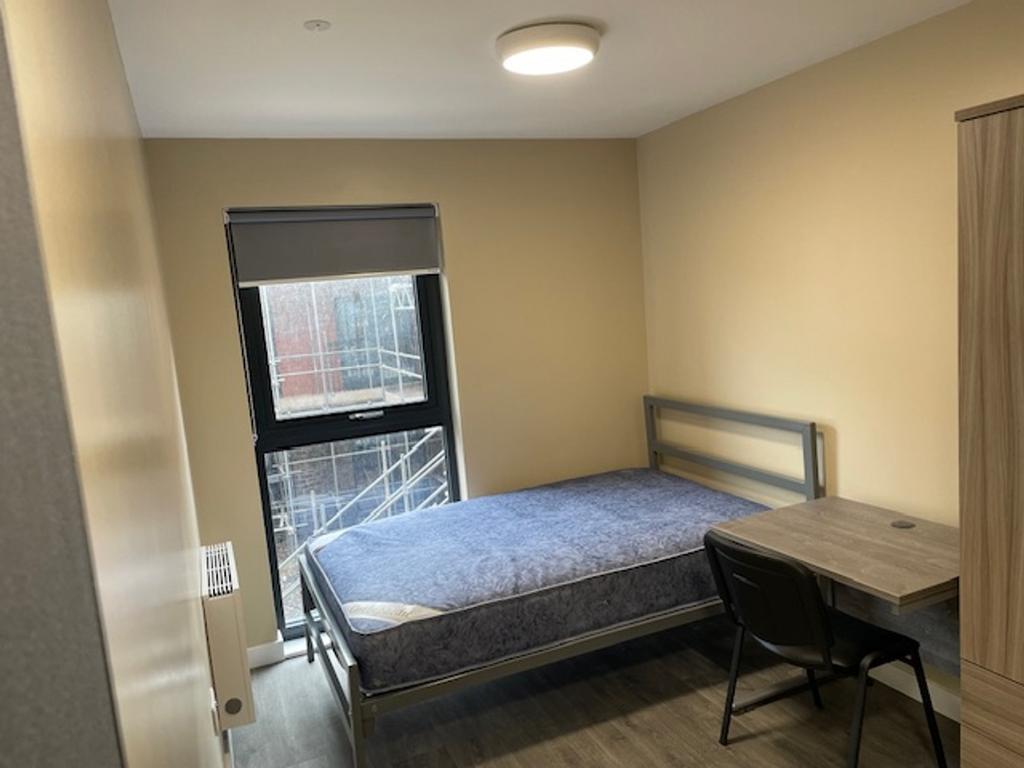 Bright and spacious double bedroom featuring a ...
