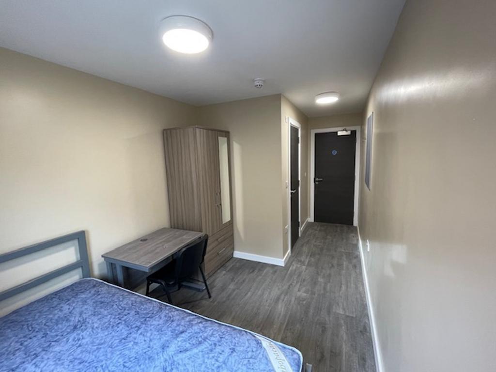 Spacious double bedroom featuring a comfortable...