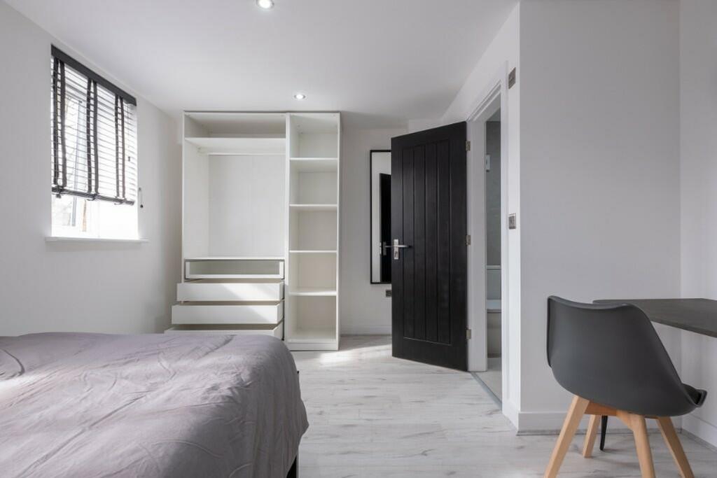 A bright and spacious double bedroom featuring ...