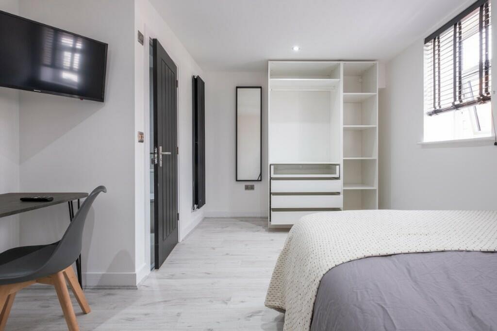 A stylish and well-lit double bedroom featuring...