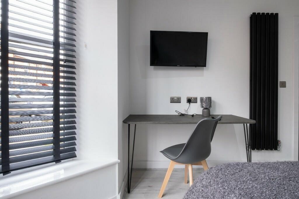 A stylish double bedroom featuring a modern des...