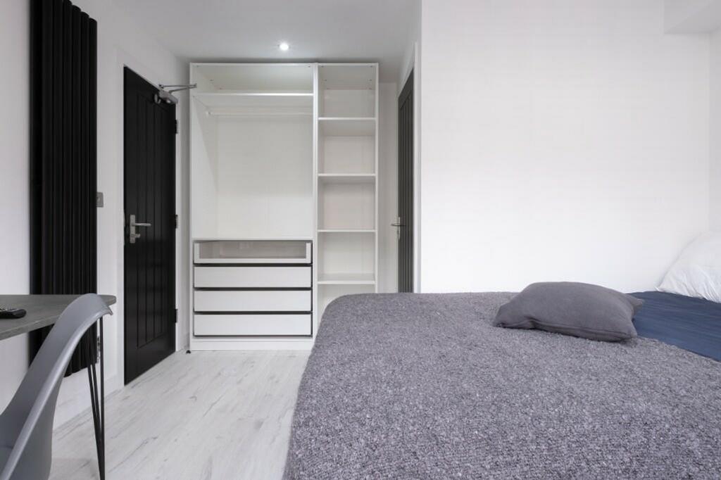 A stylish and modern double bedroom featuring a...
