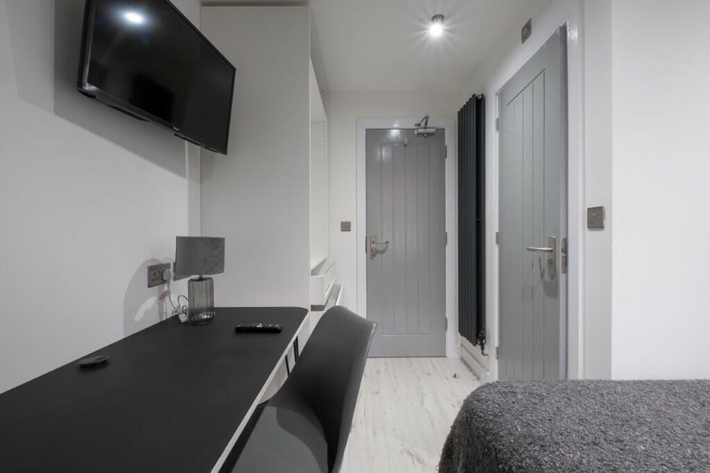 This charming double bedroom offers a cozy retr...