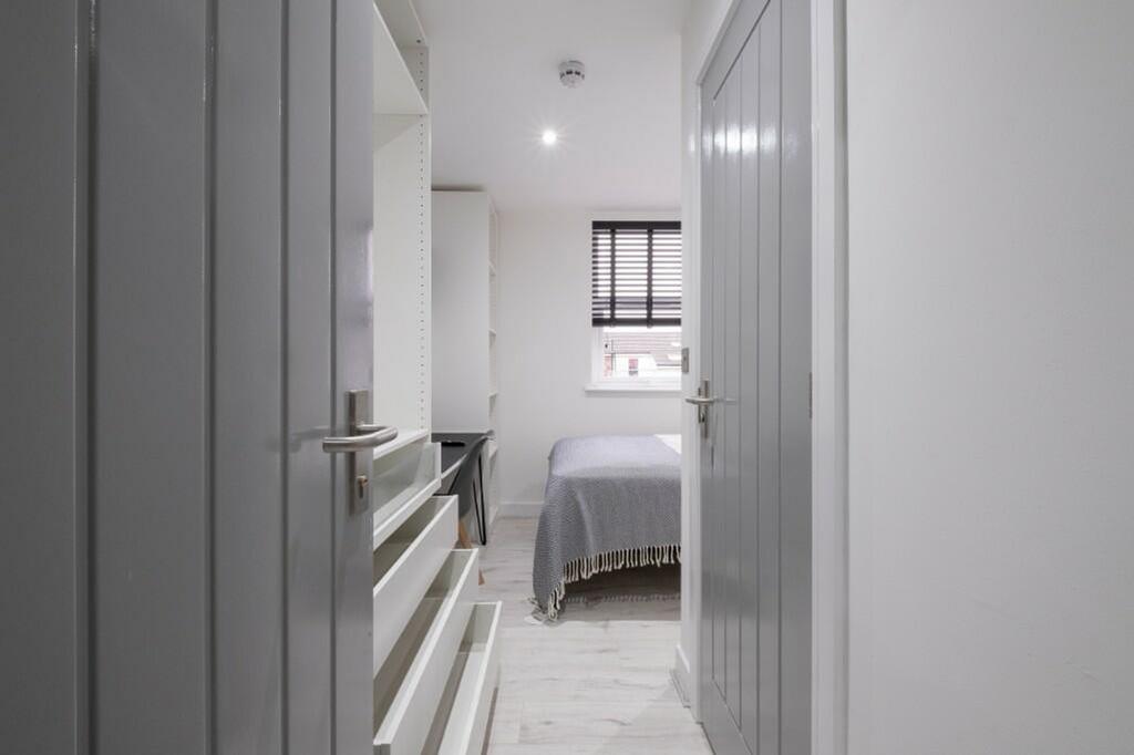 This inviting double bedroom features a cozy la...