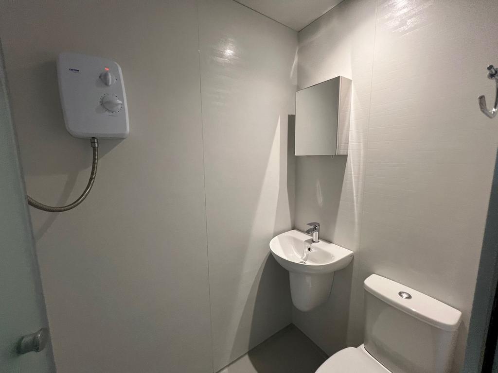 Compact modern bathroom with a wall-mounted bas...