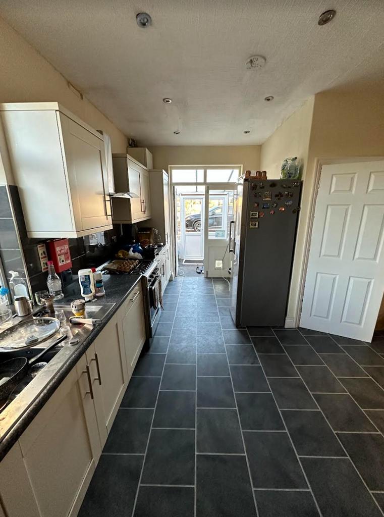A spacious kitchen with modern appliances and g...