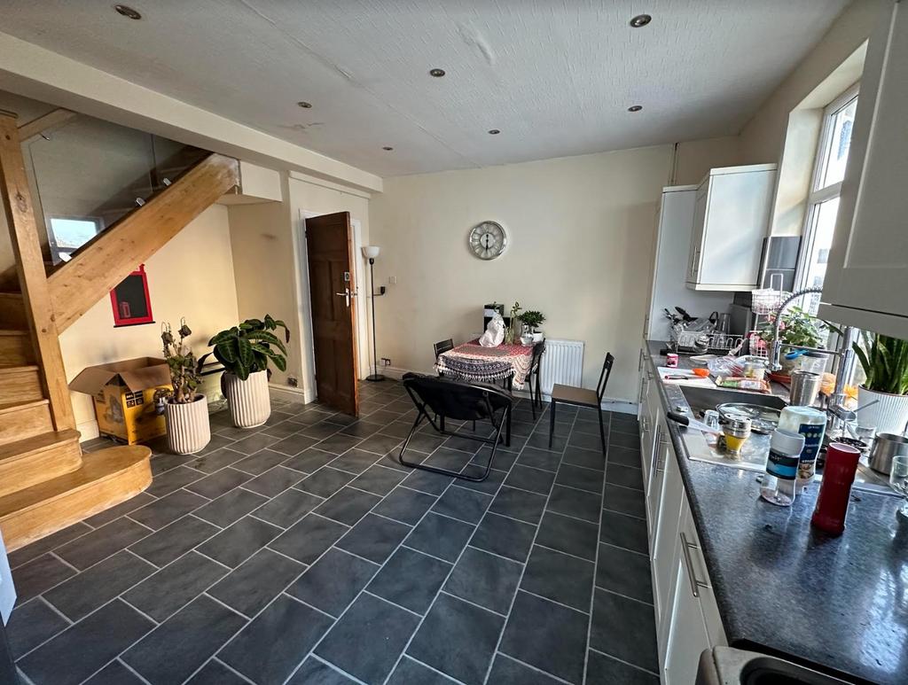 A spacious kitchen featuring a comfortable dini...