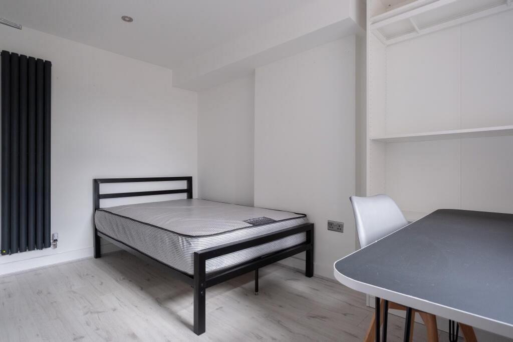 A bright and spacious double bedroom featuring ...
