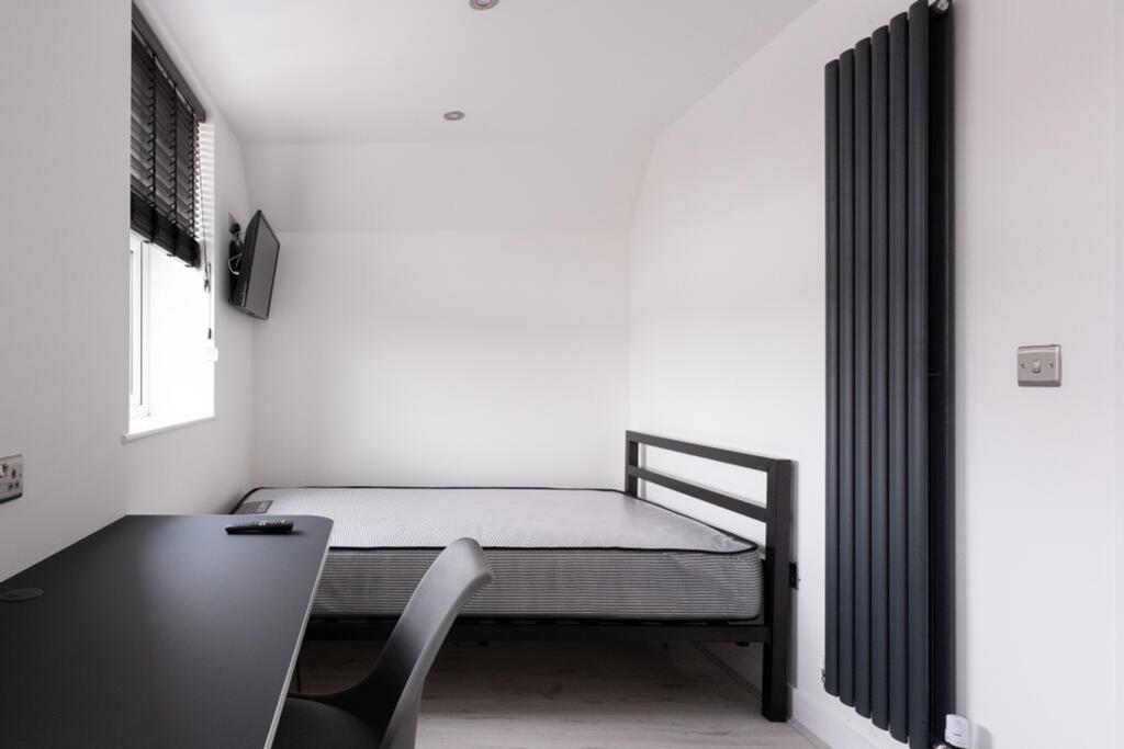 Bright and modern double bedroom featuring a st...