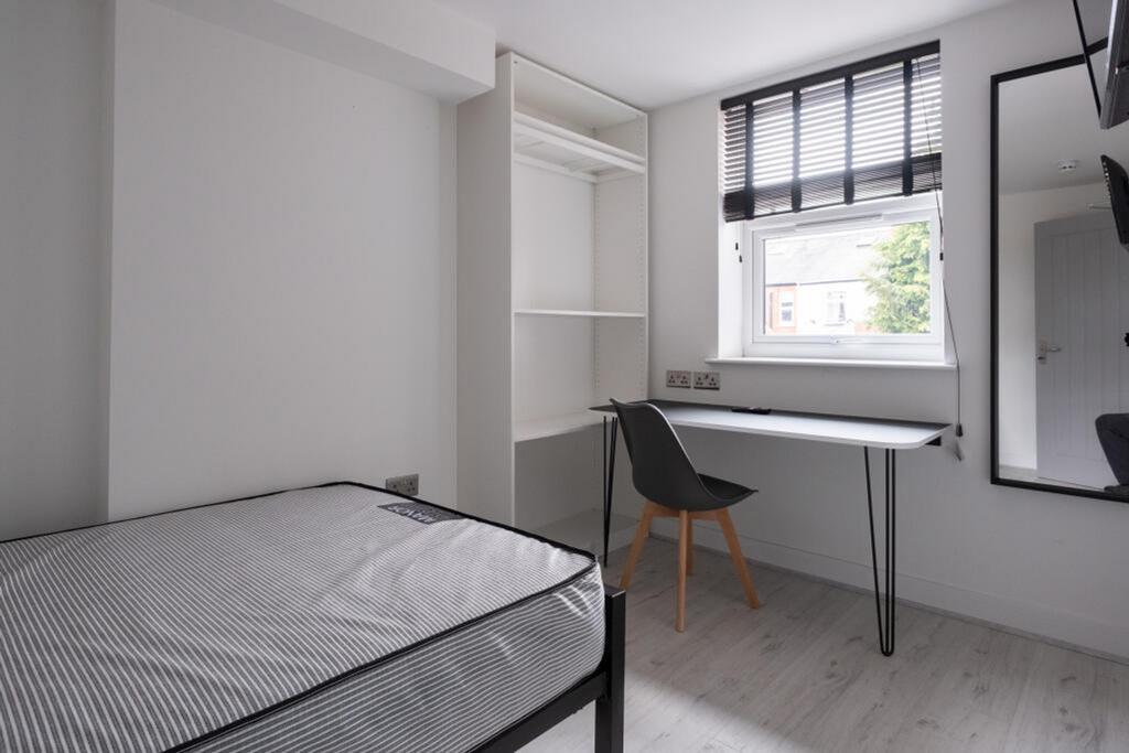 Bright and modern double bedroom featuring ampl...