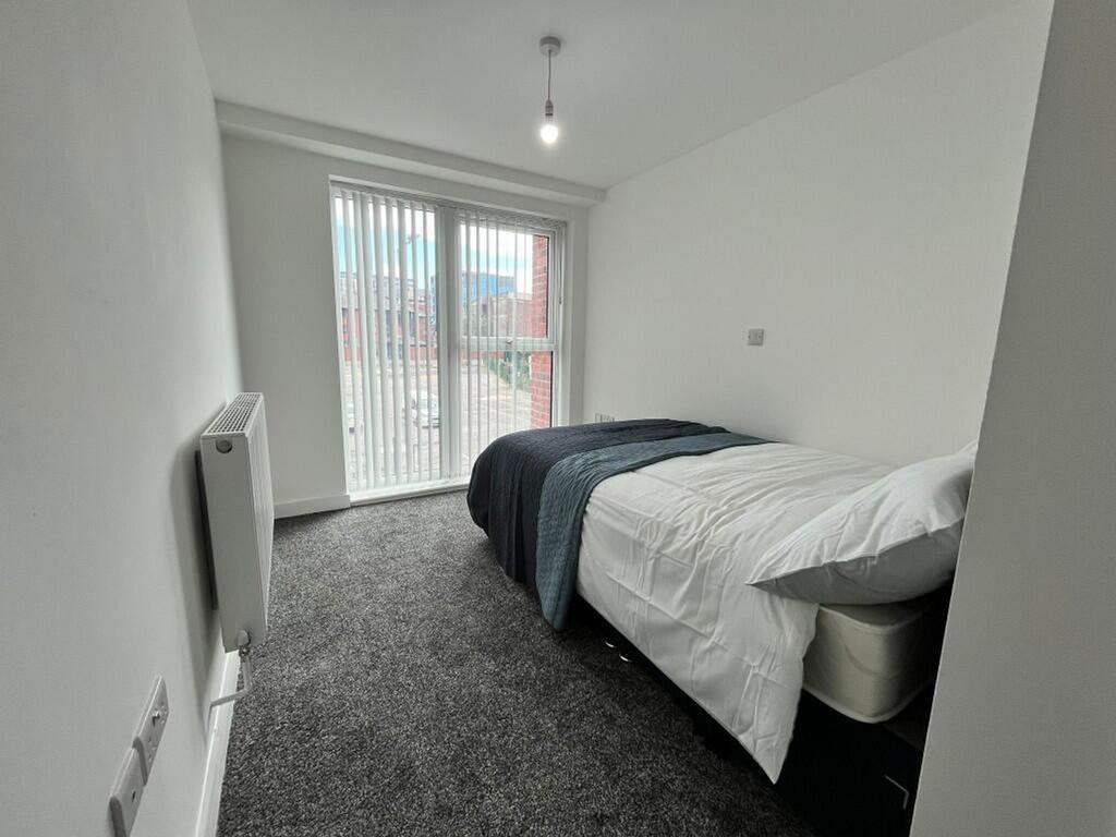 Bright and inviting double bedroom featuring la...