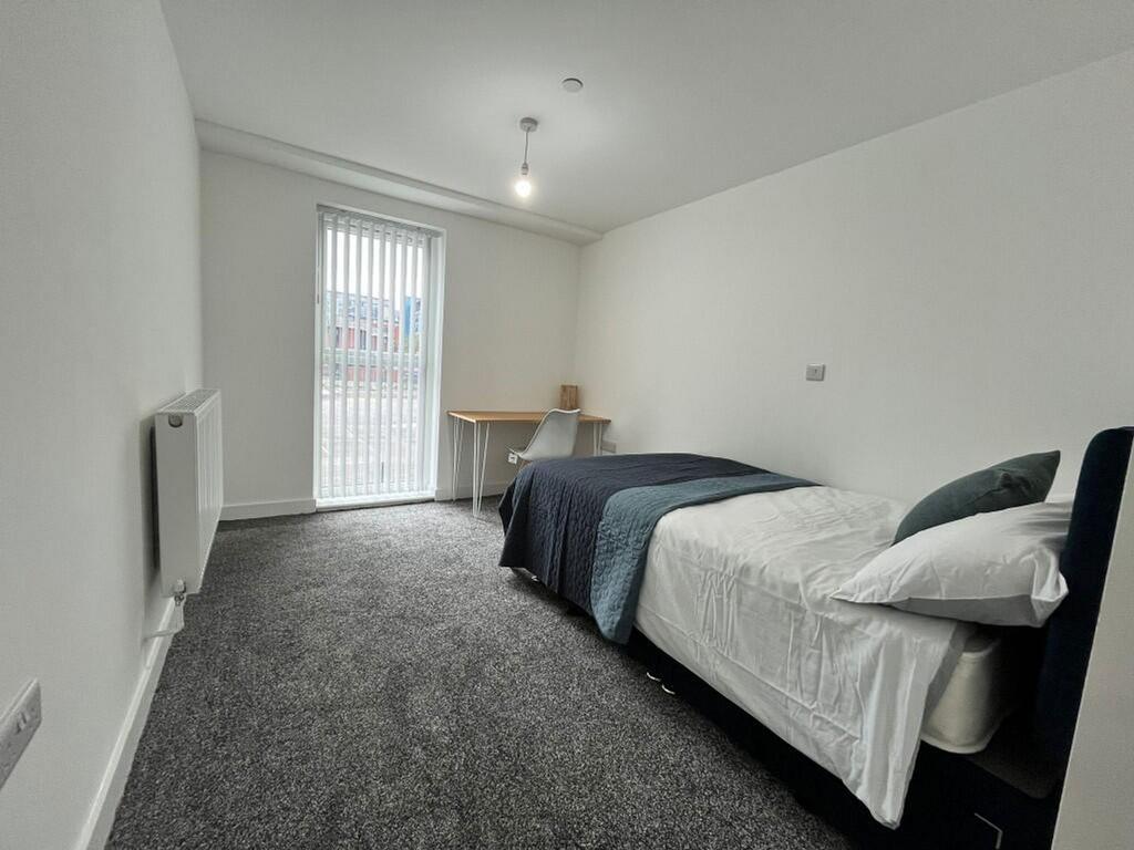 Spacious double bedroom featuring a comfortable...