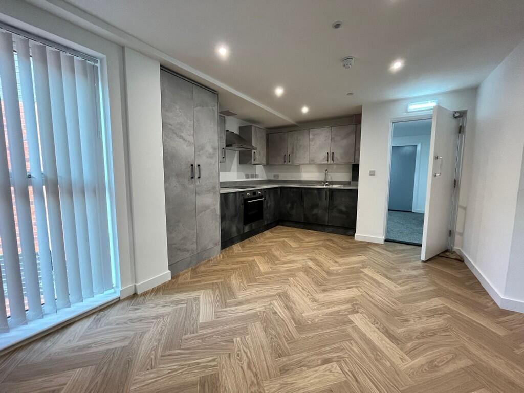 Modern kitchen featuring sleek cabinetry, ample...