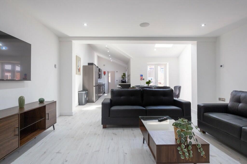 Spacious and contemporary living room featuring...