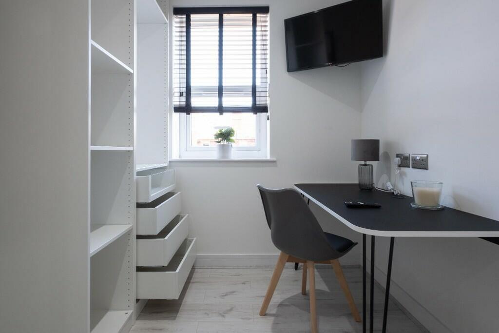 This modern communal workspace features a sleek...