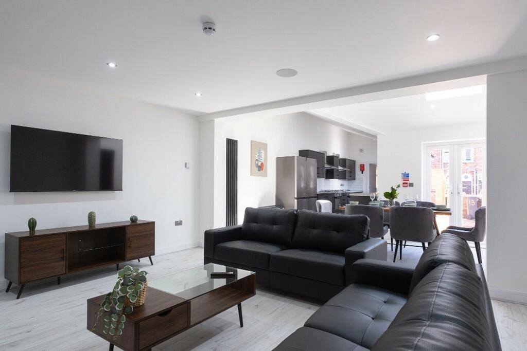 Spacious and contemporary living room featuring...