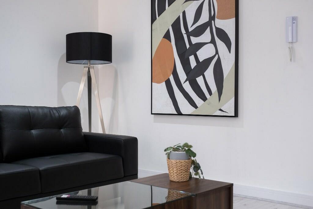 A stylish living room featuring a sleek black s...