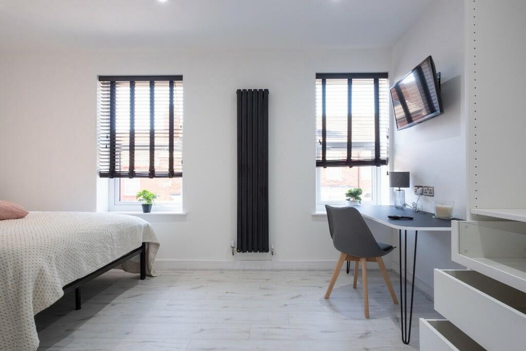 This inviting double bedroom features a comfort...