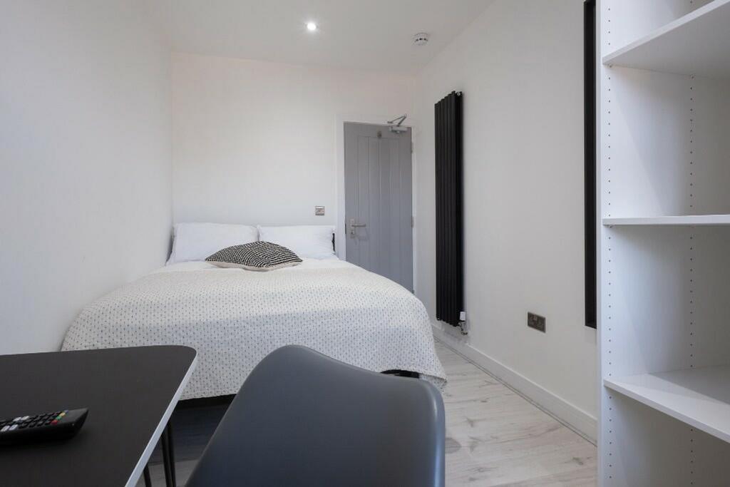 Cozy double bedroom featuring a comfortable bed...