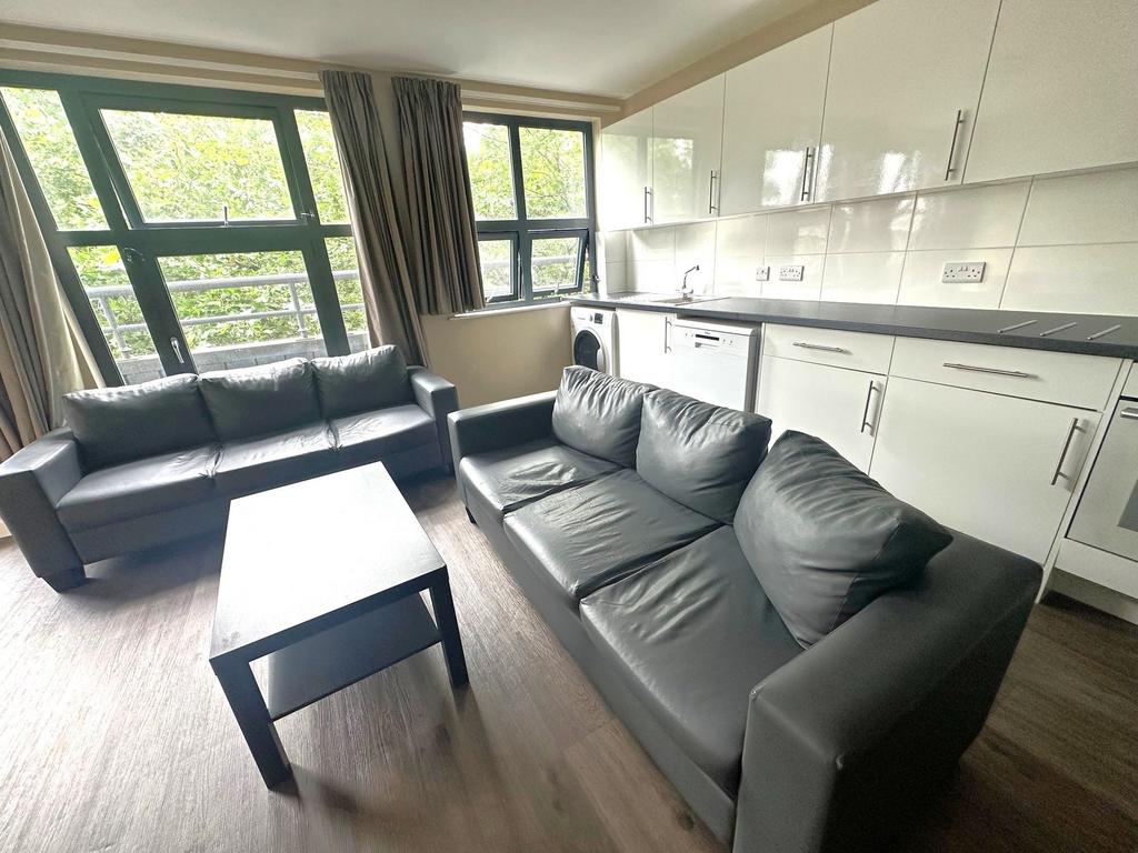 Bright open-plan living area with large windows...