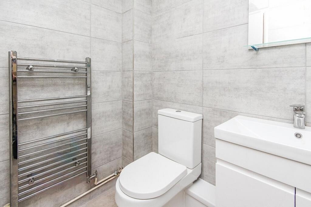 A modern bathroom featuring sleek tiles, a styl...