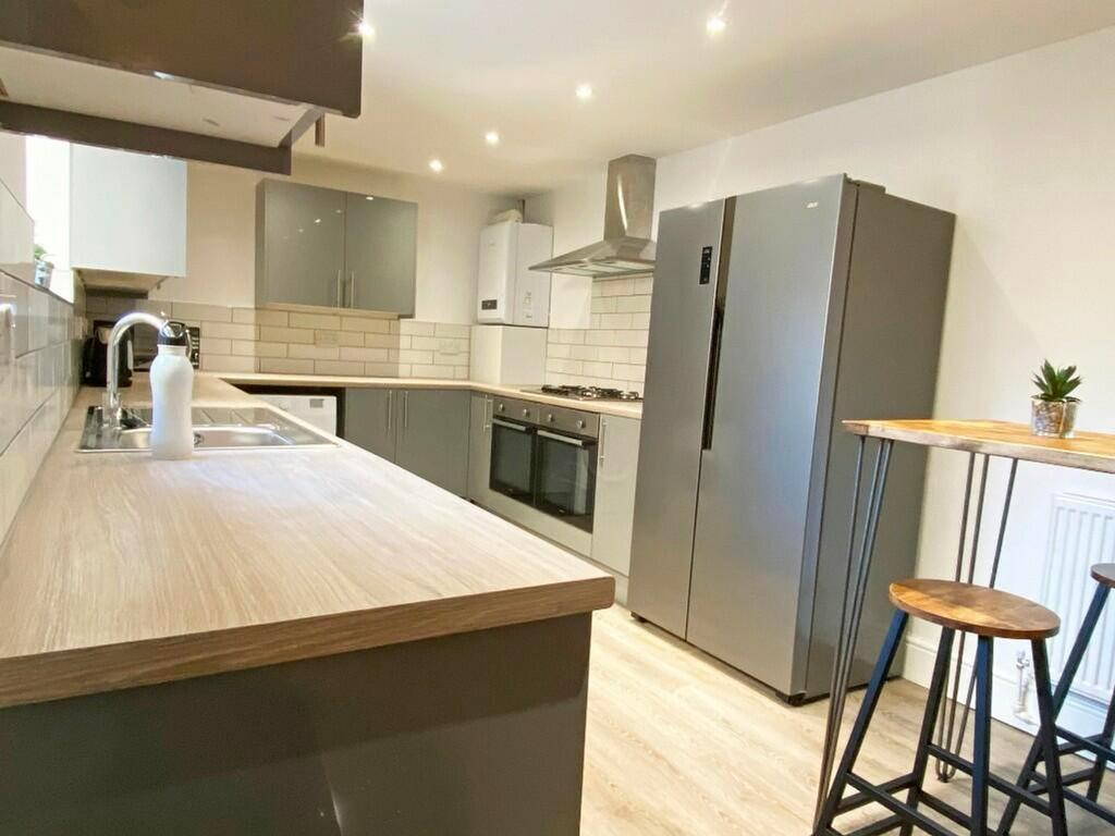 A modern and spacious kitchen with sleek applia...