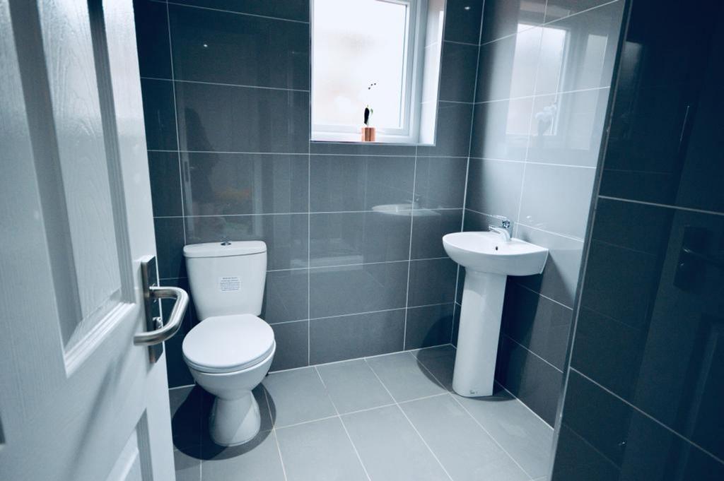 Contemporary bathroom featuring sleek gray tile...