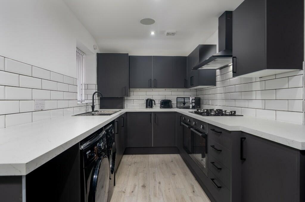 A modern and stylish kitchen with ample counter...