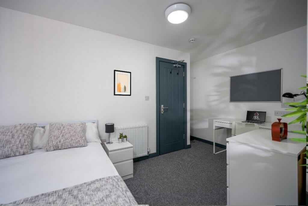 A bright and spacious double bedroom featuring ...
