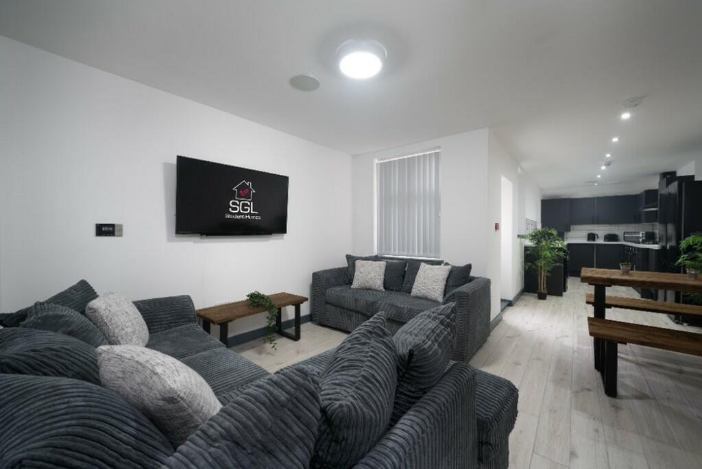 A spacious and modern living room featuring com...