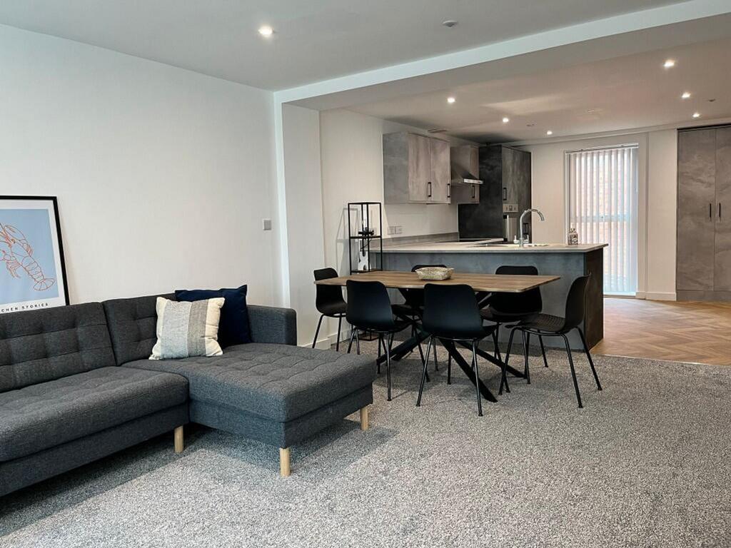 A spacious and well-lit modern living room, per...